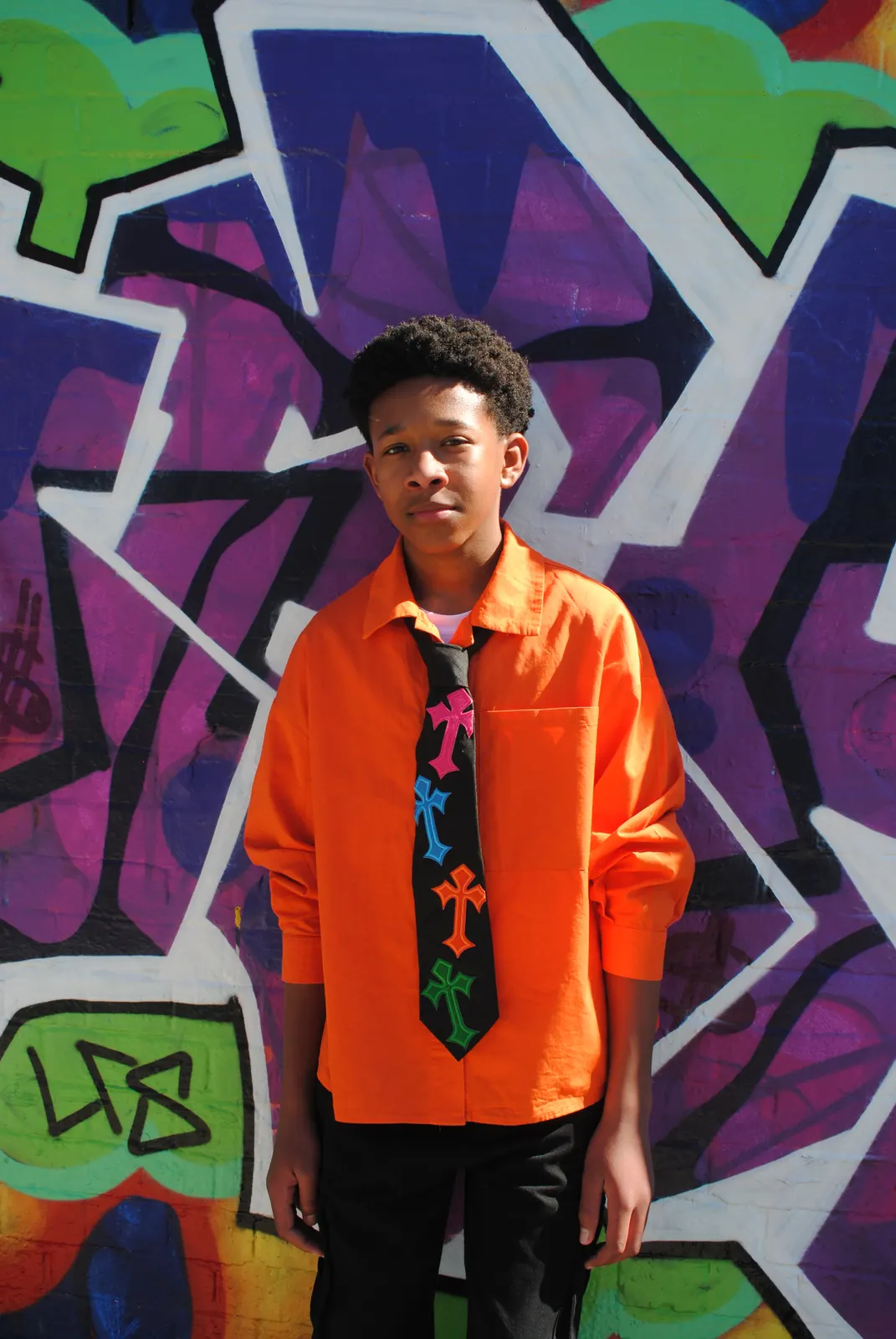 Reworked statement tie with embroidered cross patches in pink, blue, orange and green